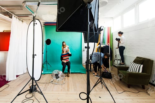 Preview: Fashion models getting dressed while assistants working in studio