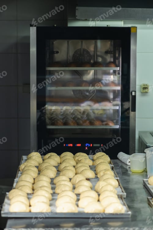 Preview: Balls of dough in a baking pan, going into a restaurant oven