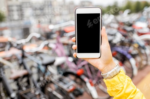 Preview: Holding a phone on the bicycle parking background