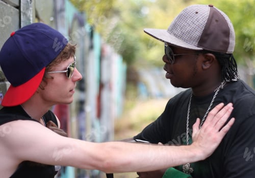 Preview: Chill bro. Shot of two young men getting into a fight.