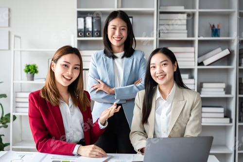 Preview: Three women in business attire are smiling