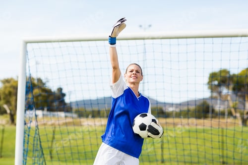 Preview: Female goalkeeper holding a ball and gesturing