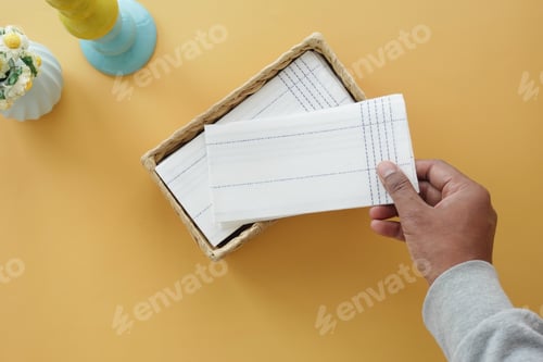 Preview: hand pull out a piece of tissue from tissue paper box