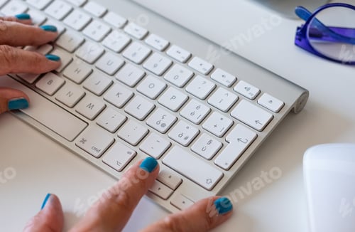 Preview: Working at home with computer, woman writing a blog. Female hands on keyboard