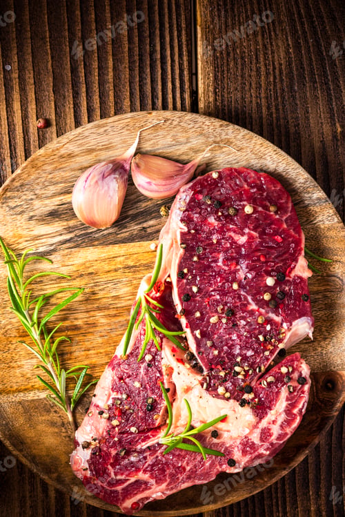 Preview: Beef Steak Meat on Wooden Plate with Herbs and Spices