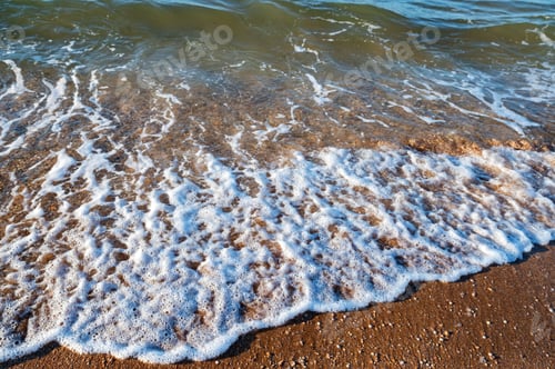 Preview: Close up of sea water runs onto the sandy shore