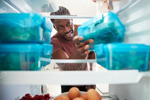 Preview: View Looking Out From Inside Of Refrigerator As Man Takes Out Healthy Packed Lunch In Container