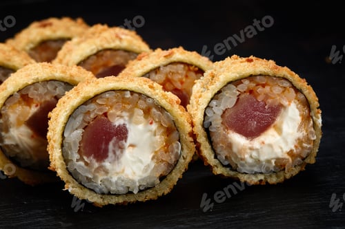 Preview: Hot fried sushi roll with salmon. Sushi menu. Japanese food. Hot fried sushi roll on black