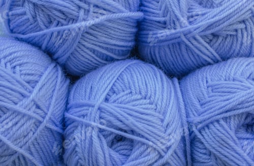 Preview: Blue balls of yarn. Closeup Warm wool yarn background. Knitting hobby. Row of Blue yarn.