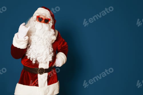 Preview: Authentic Santa Claus wearing sunglasses on blue background. Space for text