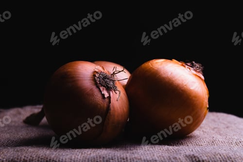 Preview: Closeup shot three fresh onions on a black isolated background