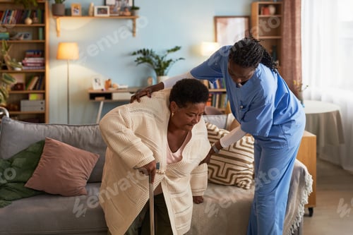 Preview: Elderly Black Woman Receiving Assistance from Female Nurse Indoors