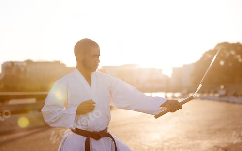 Preview: His technique is flawless. A young karate professional practicing while wearing a gi.