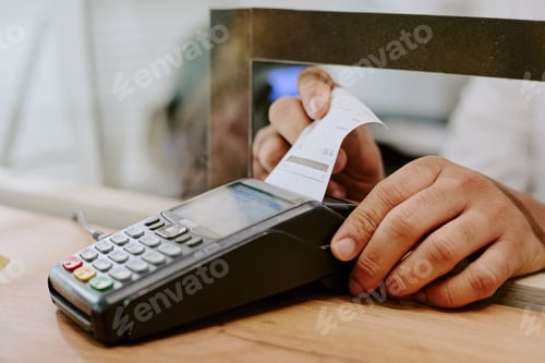 Preview: Hand Holding Receipt Near Payment Terminal