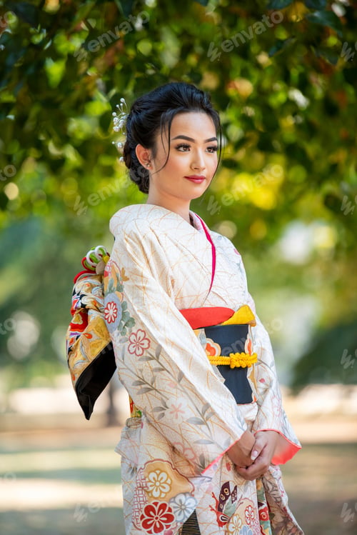 Preview: Elegant woman in traditional kimono under the shade of trees
