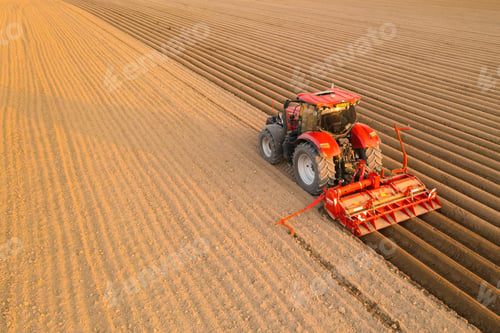 Preview: Contemporary tractor drags plug making furrows on soil