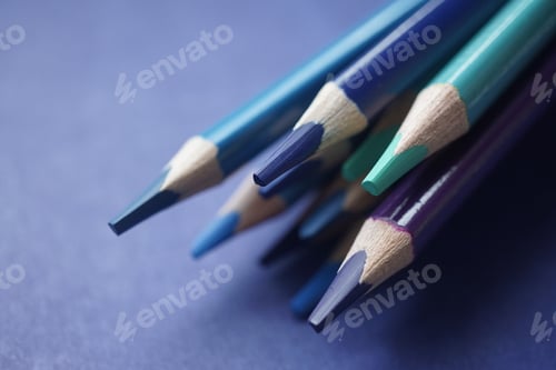Preview: Colorful Pencils Pointing on a Blueish Background