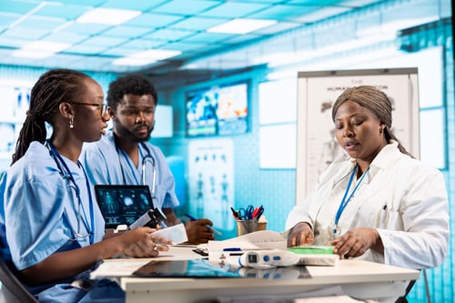 Preview: Male and female young nurses in scrubs engaged in professional training