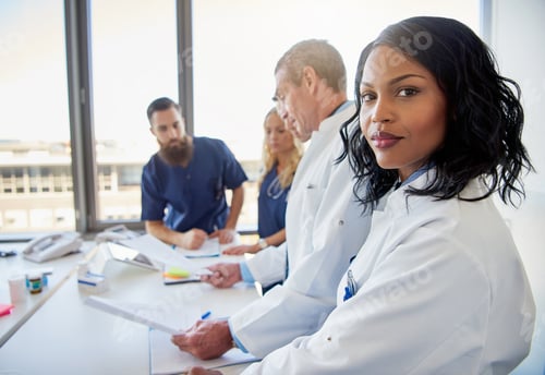Preview: Female doctor looking at camera in clinic
