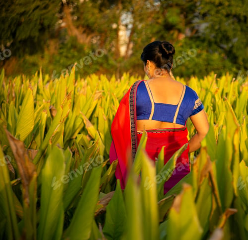 Preview: Happy woman walking in the turmeric field.