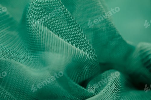 Preview: the close up image of a teal green Net cloth on display
