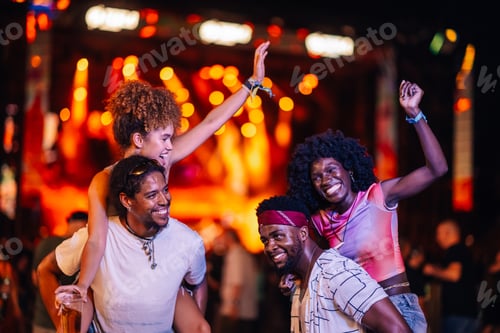 Preview: Friends enjoying live music at night festival
