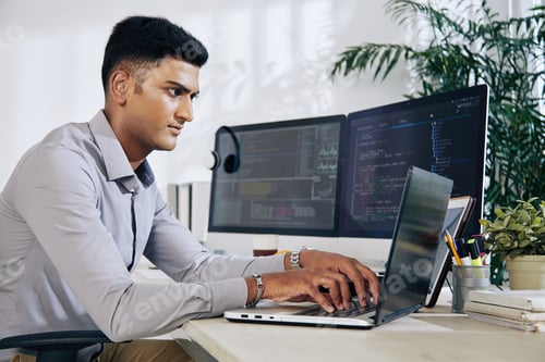 Preview: Programmer typing on laptop