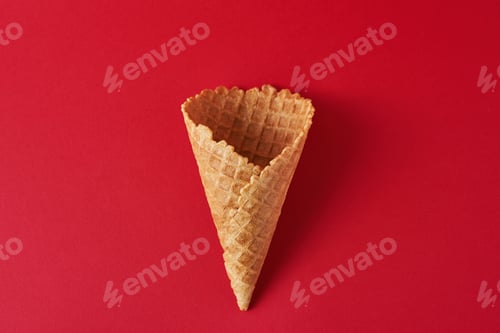 Preview: Empty ice cream cone on the red background, top view flat lay. Minimalism style creativity concept