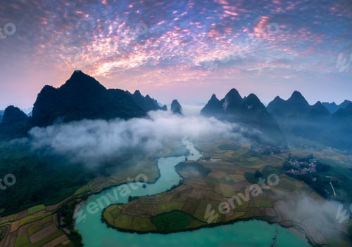 Preview: Sunrise over mountain range with foggy on rural village and river flows through in Phong Nam Valley