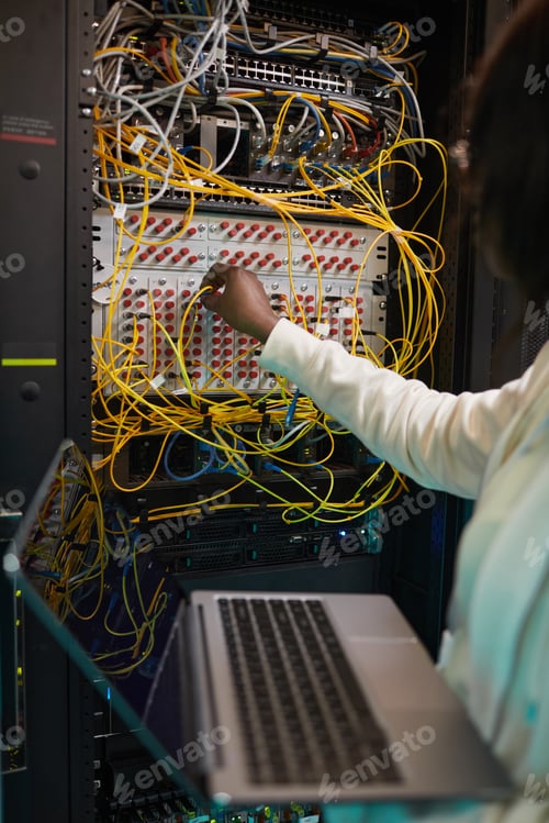 Preview: Female Network Technician Connecting Cables Close Up