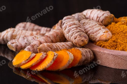 Preview: turmeric powder and roots on wooden background