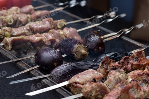 Preview: Grilled meat and vegetables on skewers at a street food festival.