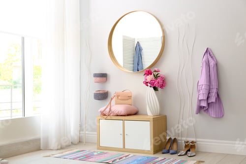 Preview: Stylish hallway interior with round mirror on white wall