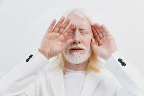 Preview: Emotional man with long white hair and beard, wearing a white suit, expressing deep feelings with