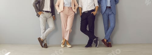 Preview: Group of business people in suits standing in office, low section shot of human legs
