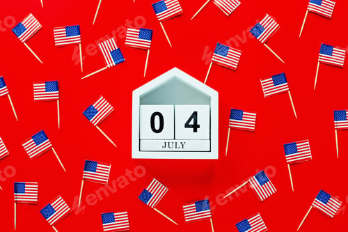 Preview: July 4th. Mockup of july 4 wooden color calendar and USA flags on red background. Independence Day
