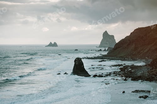 Preview: Lonely cliff in sea on cloudy day