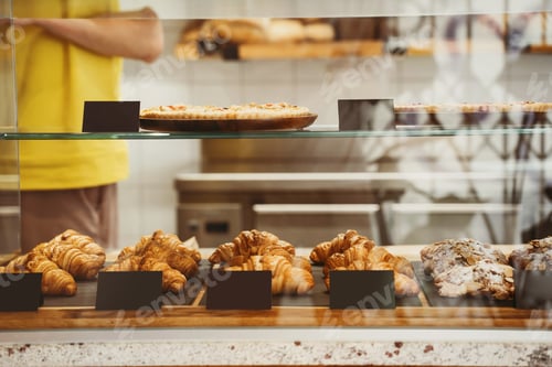 Preview: Bistro showcase with shelves of freshly croissants and bread in assortment.