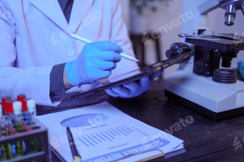 Preview: Close-up of a male scientist analyzing blood vessels in a modern laboratory. He is experimenting