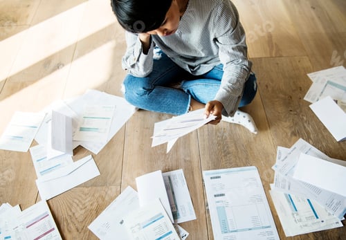 Preview: Sorting out a pile of bills on the floor