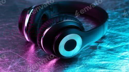 Preview: Retro 90s style photo of black stylish wireless headphone in neon lights.