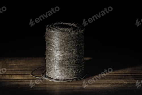 Preview: Brown thread on wooden table