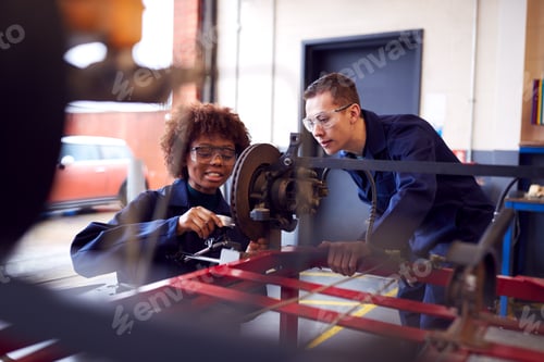 Preview: Male And Female Students Working On Car Brakes On Auto Mechanic Apprenticeship Course At College