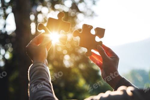 Preview: A woman holding and putting a piece of wooden jigsaw puzzle together in the outdoors