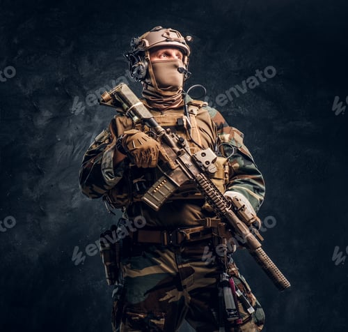 Preview: Elite unit, special forces soldier in camouflage uniform posing with assault rifle.