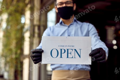 Preview: Close-up of waiter holding open sign.