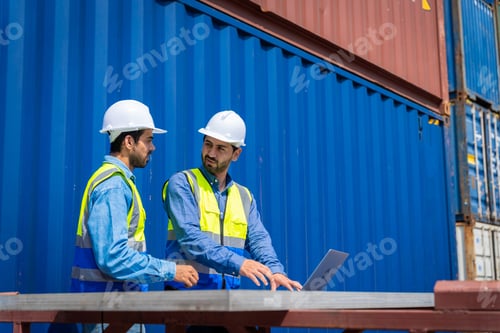 Preview: Two male engineers in a container shipping company