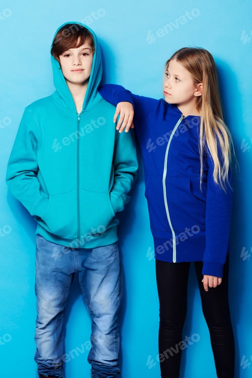 Preview: Hes too cool. Portrait of a young boy with a young girl leaning on him in the studio.