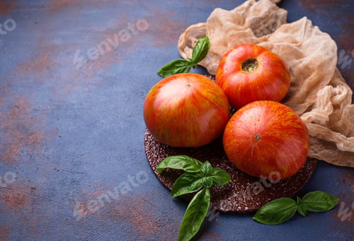 Preview: Fresh tomato on blue rusty background.