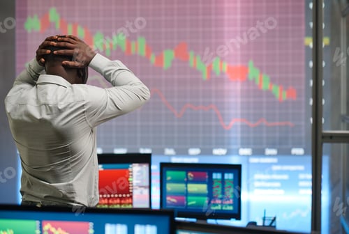 Preview: Unrecognizable Black man wearing white shirt working in stock trading company looking at graph